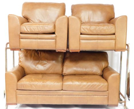 A brown leather three piece suite, comprising three seat sofa with shaped arms and block feet, and two matching armchairs, th