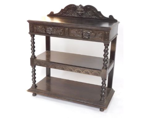 A Victorian ebonised oak buffet, with a foliate carved back, above two frieze drawers with mask handles, over two further tie
