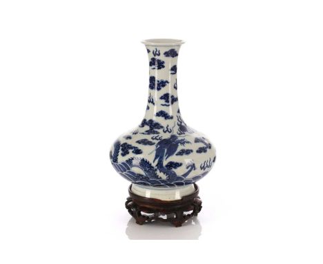 A Chinese blue &amp; white dragon vase, Qing, 19th/20th century, with flaring rim above a long neck and compressed baluster b