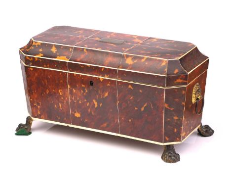 A Regency tortoiseshell and ivory tea caddy, of sarcophagus form on four lion paw feet, with twin removable compartments and 