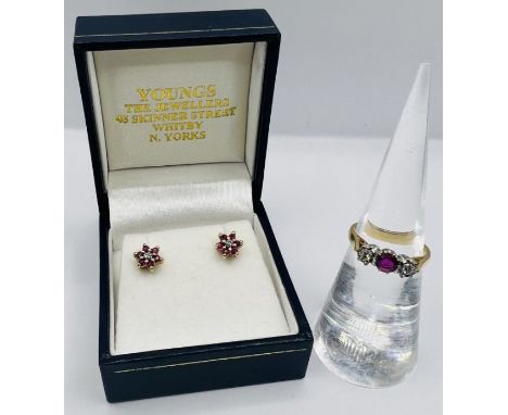 An 18ct gold ruby and diamond trilogy ring, along with a pair of ruby ear studs, stamped 375. The ring is a size K and weight