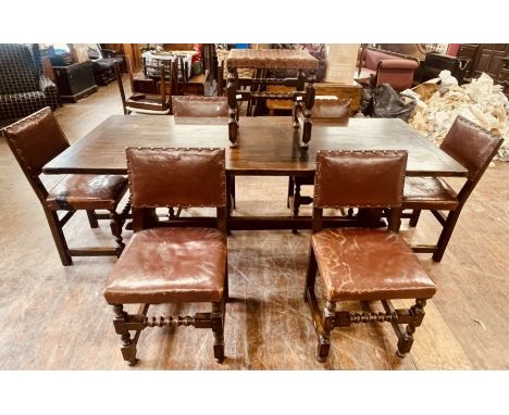 A 17th century revival oak refectory table, two plank top with cleated ends, raised on carved trestle supports united by a st