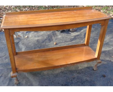 A 20th century oak console table, quarter gallery back, moulded edge top, above an under tier shelf, raised on short ogee sup