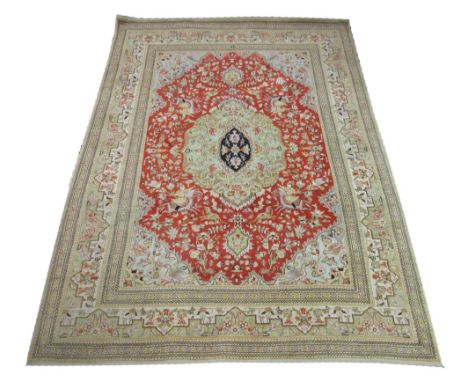 TABRIZ CARPET, 263cm x 186cm, central medallion with palmettes and vines on a burnt orange field and jade spandrels within an