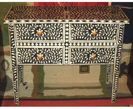 CHEST, ebonised and bone inlaid of four short drawers with gilt handles, 75cm H x 90cm W x 38cm D. 