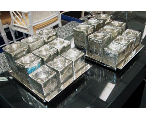 TEA LIGHT VOTIVES, a pair, on trays, stepped, plated holders, 23cm x 27cm x 13cm H. (2)