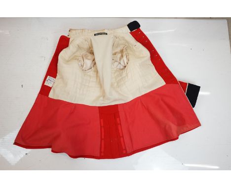 A British army Scotts Guards tunic complete with associated buttons, belt and badges together with mannequin. 