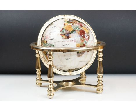 A contemporary table top globe made with semi precious stones on gilt metal frame with compass to base. 