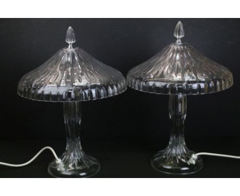 Pair of Waterford Crystal table lamps. Each lamp having finial tops with glass faceted shaped and waisted bodies. Each houses