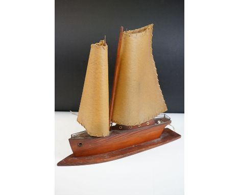 Art Deco table lamp in the form of a boat of wooden construction with two hide sails. Measures 41cm high x 45 cm wide 