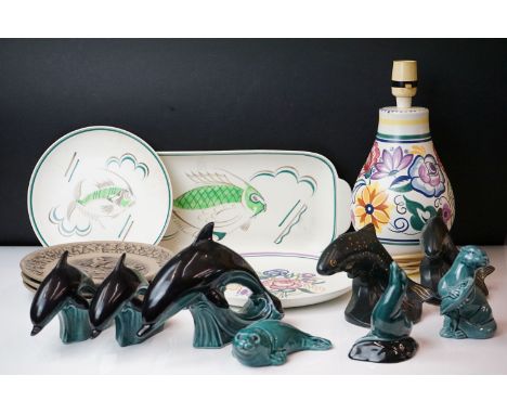 Collection of Poole pottery to include two trout, three dolphins, otter, seal, manitee, matching fish tray and plate, lamp ba