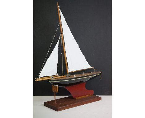 A vintage wooden pond yacht complete with stand. 