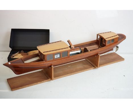 A kit built wooden model steam boat together with a box of spare parts. 