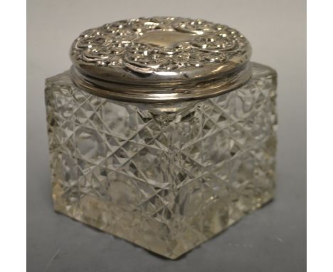 A large cut glass dressing table jar, silver cover, London 1902.