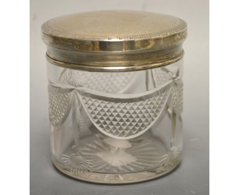 A heavy swag cut dressing table jar, silver lid, Birmingham 1921