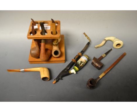 A collection of eleven pipes and pipe rack