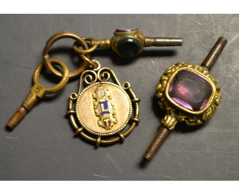 A Victorian gold stone set watch key; another, similar; a fob