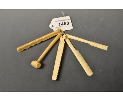 A set of 19th century ivory novelty teethers, carved as tools and implements