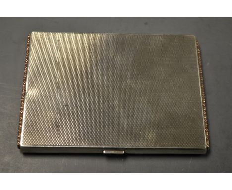 A silver cigarette case, gold mounted side strips, Birmingham 1932