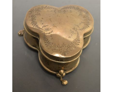 A George V silver trefoil dressing table trinket box, hinged cover engraved with ribbon-tied flowering leafy swags, pad feet,