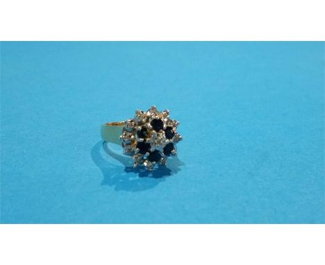 A 9ct gold cluster ring, mounted with diamonds and sapphire. 4.7 grm
