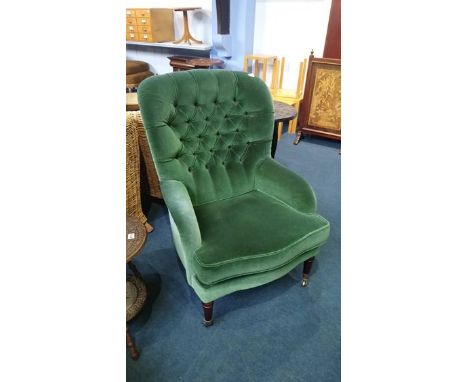 A modern green upholstered button back armchair