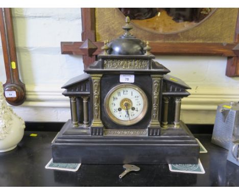 A late Victorian slate mantel clock, of architectural form with domed top and columns, the twin train movement striking on a 