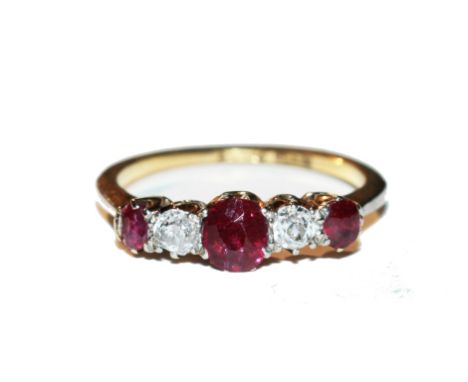 A five stone diamond and ruby ring set in 18 carat gold