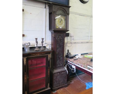 A mid 18th century oak longcase clock, with later carving to the matched case, the brass dial with gilt mask spandrels, silve