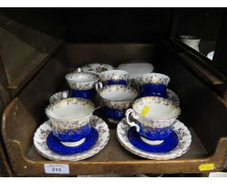 A set of six Royal Albert blue and gilt teacups and saucers, a Royal Worcester lidded pot and another by Poole pottery