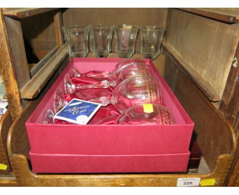 A set of four Bohemian crystal wine glasses by Henry Marchant, cased, four other wine glasses and a cased set of seventy-two 