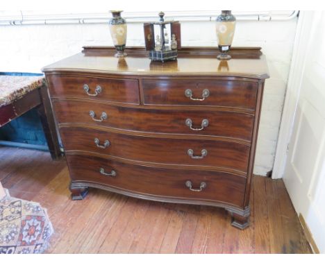 A George III style serpentine chest of drawers by Waring & Gillow, the moulded back and edge over two short and three long gr