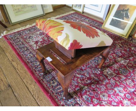 A stained beech gout stool, with hinged upholstered seat and cabriole legs