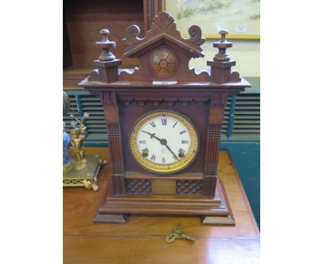 An Edwardian Ansonia walnut cased mantel clock, with architectural pediment, the twin train movement striking on a gong, 38cm