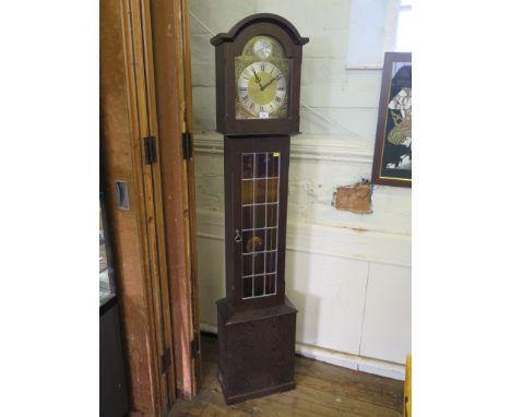 An oak miniature longcase clock with brass dial and lead glazed door, the three train movement striking on gongs, 175cm high