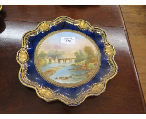 A set of ten late 19th Century English Porcelain scallop shape plates, each  painted with a landmark, (inscribed verso) with 