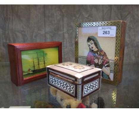 Three decorative boxes, one with reverse painted ship to glass lid, another with fine coloured sands portrait of an Indian gi