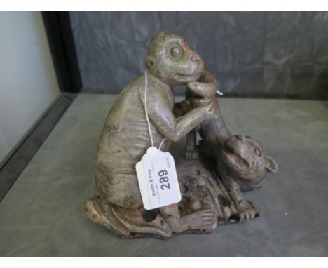 A soapstone figure of a monkey playing with a dog, 14cm high