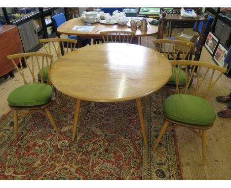 An Ercol ash dropleaf dining table 113cm wide, and a set of five ash spindle back dining chairs, labelled