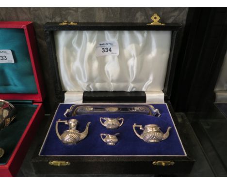 A cased miniature silver tea set and tray