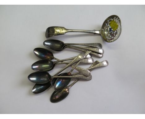 A collection of silver tea spoons, a sifter spoon, a silver label etc 