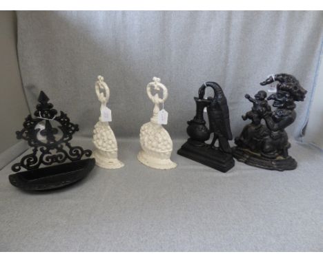 'Mrs Punch' cast iron door stop, a pair of white painted cast iron door stops, another old door stop & another item