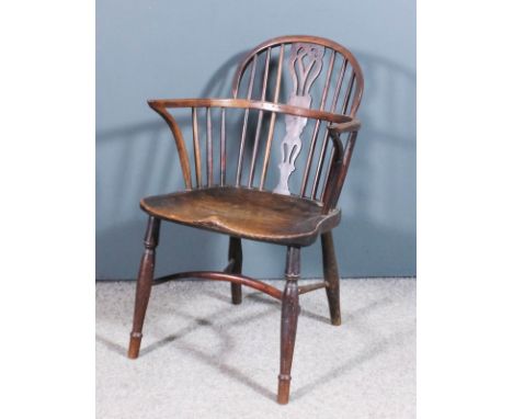 A 19th Century Nottinghamshire yew and elm seated low back Windsor armchair, the two tier stick back with fretted centre spla