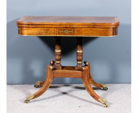 A George IV rosewood and gilt brass mounted D-shaped card table, the baize lined folding top crossbanded and inlaid with sati