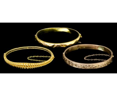 A late Victorian 15ct gold stiff bangle with rope twist decoration (gross weight 14 grammes), a modern 9ct rose gold stiff ba
