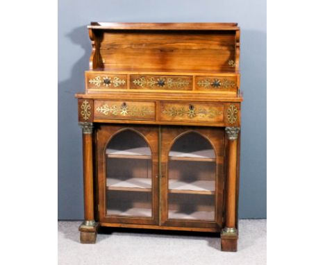 A George IV rosewood and brass inlaid chiffonier inlaid with stringings and leaf scroll ornament, the upper part with open sh