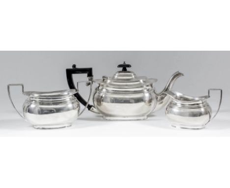 A George V silver rectangular three piece tea service with moulded collars and angular loop handles, comprising - teapot with