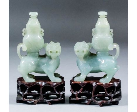 A pair of Chinese green/grey celadon jade figures of Kylin with two-handled vases and covers to their backs, 3.875ins (9.8cm)