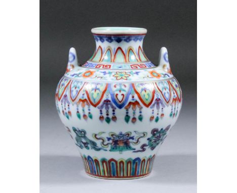 A small Chinese doucai porcelain two-handled ovoid vase painted with eight Buddhist emblems within bands of formal lappets, p