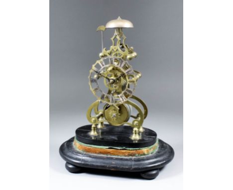 A 19th Century brass skeleton clock, the 4.25ins diameter silvered and fretted dial with Roman numerals, the eight day fusee 